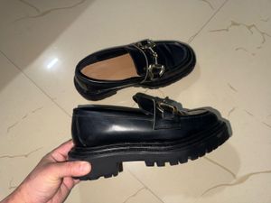 Chic Black Loafers with Gold Bit Detail