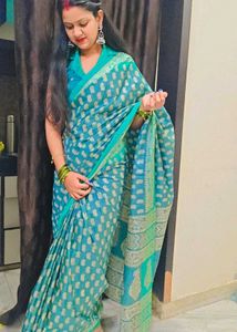 Elegant Teal Saree with Intricate Gold Patterns