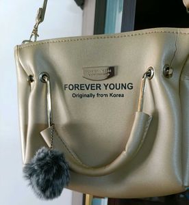 FOREVER YOUNG Beige Handbag with Pom Po