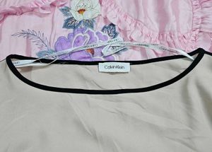 Calvin Klein Women's soft pink hue or light cream.