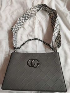 Stylish Grey Handbag with Geometric Strap