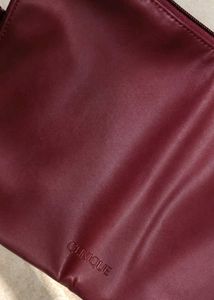 Clinique burgundy Leather Bag.