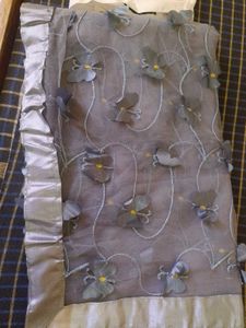 Gray net saree with butterfly patch work.