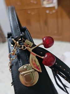 Chic Black Embossed Hobo Bag with Charms