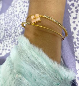 Elegant Gold-Tone Bangle with Gemstones