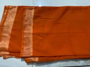 Elegant Orange Saree with Golden Border and  uns