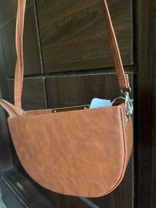 Tan brown half moon sling bag
