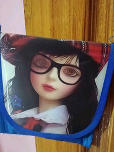 Blue purse with barbie in front