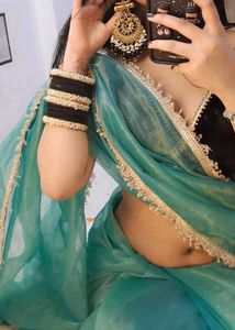 Elegant Teal Saree with Embellished Border