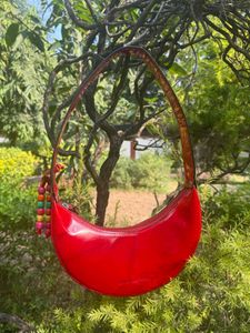 Shop Mistry Red Patent moon bag