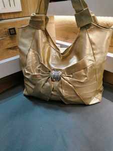 chic gold tote bag with bow accent