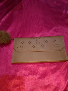 Chic Tan Clutch with Pom-Pom