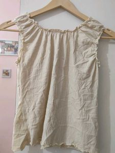 Cream ruched tie-front sleeveless top