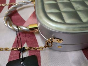 Elegant Silver Clutch with Gold Chain