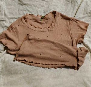 pink blouse with pearls attached