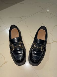 Chic Black Loafers with Gold Bit Detail