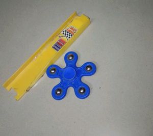Blue Fidget Spinner And A Track Toy