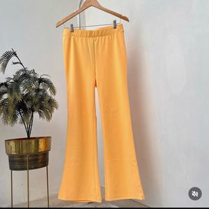 Yellow stretchable flared cotton trousers.