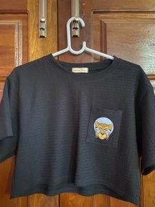 Chic Black Top with Embroidered Leopard Pocket
