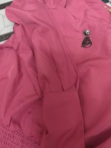 Chic Pink Smocked Top with Brooch Detail