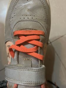 Gray sneakers with orange laces