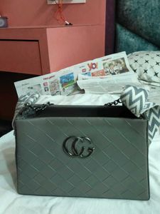 Stylish Grey Handbag with Geometric Strap