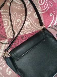 Chic Black Crossbody Bag with Gold Ring Detail