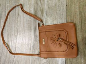 Tan crossbody bag with flower detail