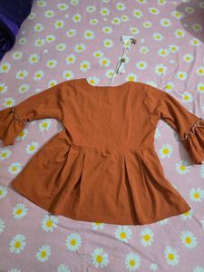Cute Orange Peplum top with Bicycle Print