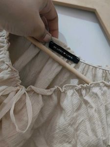 Cream ruched tie-front sleeveless top