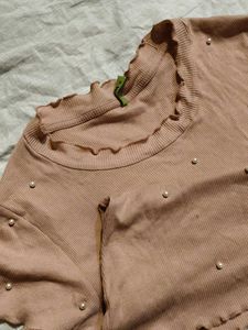 pink blouse with pearls attached