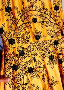 long yellow satin gown with black embroidery