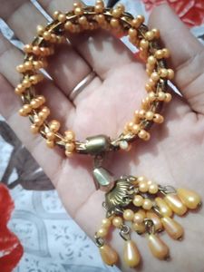 Elegant Golden Beaded Bracelet with Red Stones