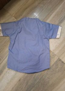short-sleeve blue  striped  shirt  and white trous