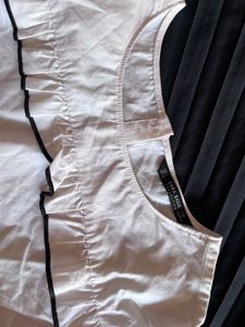 Chic White Ruffle Top with Black Trim