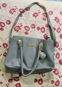 Stylish Grey Tote Bag with Pom-Pom Accent