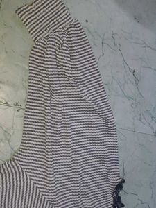 stripped knitted top with pom-poms on sleeve
