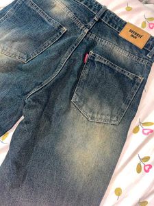 Faded indigo blue denim jeans
