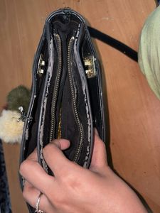 Chic Black Handbag with Pom-Pom Charm