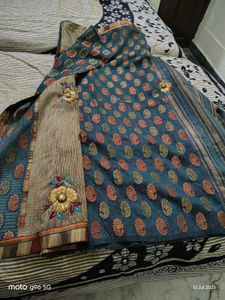 Elegant Teal Saree with Floral Motifs