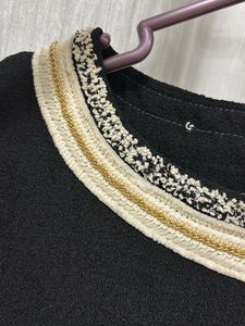 Elegant Black Dress with Embellished Neckline