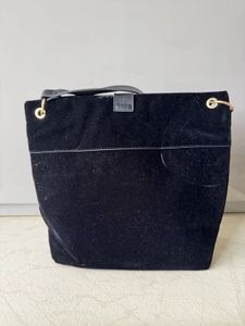 Chic Black Suede Shoulder Bag with Tassel Detail