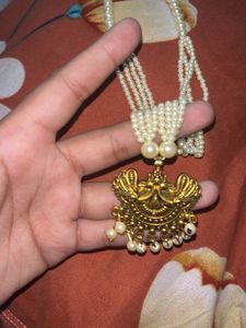 stylish indian earing with a pearl choker and ring