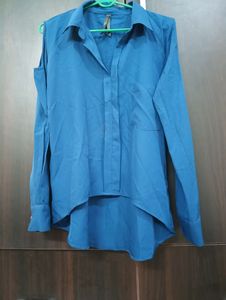 Royal Blue Top With Cold Shoulder Style. Can Be Styled Up For Office And Party Both. Bottom Style Of the Top Is High Low Style.
