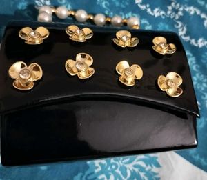 Elegant Black Clutch with Gold Flower Embellishmen
