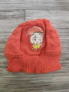 Bundle of baby clothes, beanie, shoes.