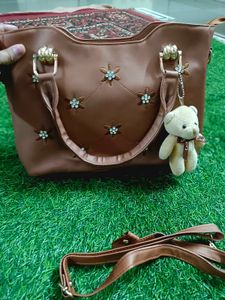 Elegant Brown Handbag with Floral Accents