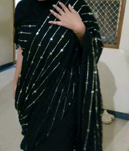 Elegant Black Saree with Golden Embellishments
