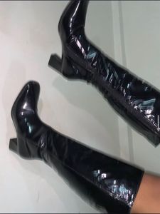 Knee length glossy boots