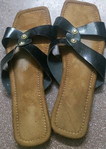 Brown and black strapped flat